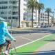 Two people biking in Ocean Ave bikeway (2000x600)