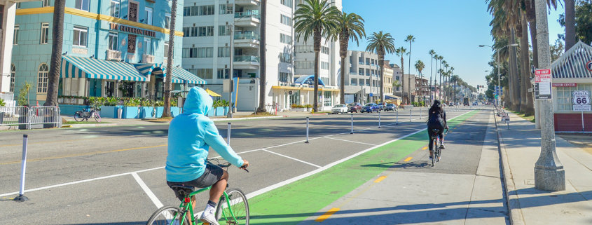 Two people biking in Ocean Ave bikeway (2000x600)
