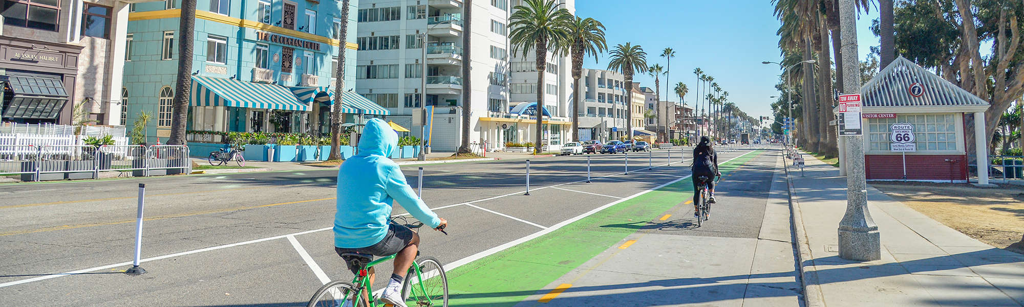 Two people biking in Ocean Ave bikeway (2000x600)