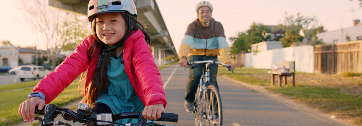 Girl with father under BART tracks Ohlone Greenway Bikeway