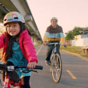 Girl with father under BART tracks Ohlone Greenway Bikeway