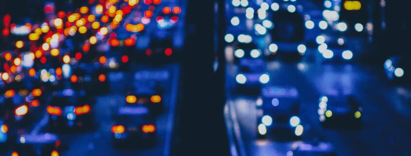 Misery depicted in blurry traffic lights on a crowded rush hour freeway.