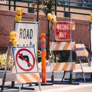 A thicket of discouraging road signs blocking roadway.