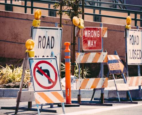 A thicket of discouraging road signs blocking roadway.