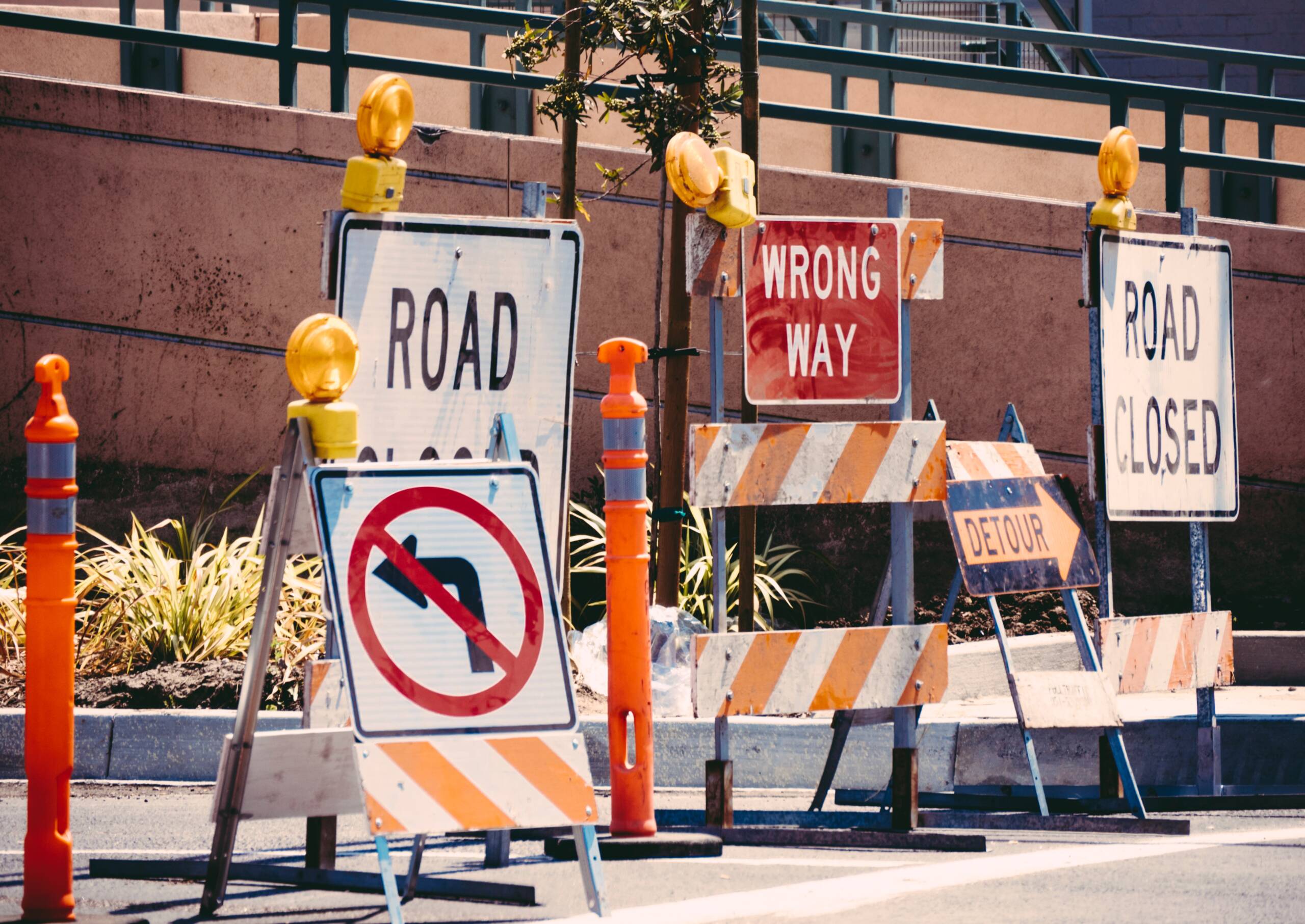 A thicket of discouraging road signs blocking roadway.