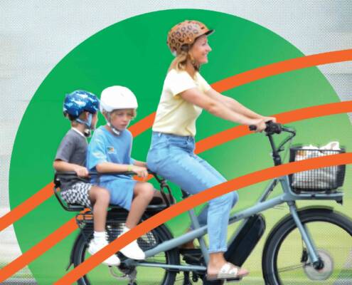 Happy family on an e cargo bike, CalBike logo at left.