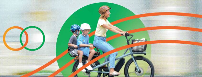 Happy family on an e cargo bike, CalBike logo at left.